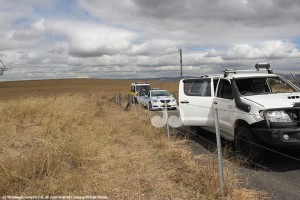 The white Toyota driven by the alleged offenders, with one of the men being treated by ambulance officers