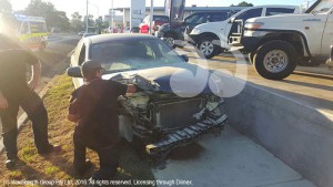 Assessing the damage to the car after it hit the light post and careered out of control.